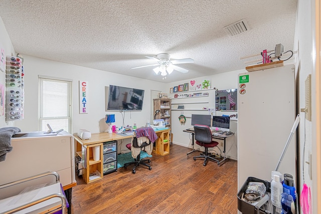 office space with a ceiling fan, wood finished floors, and a textured ceiling