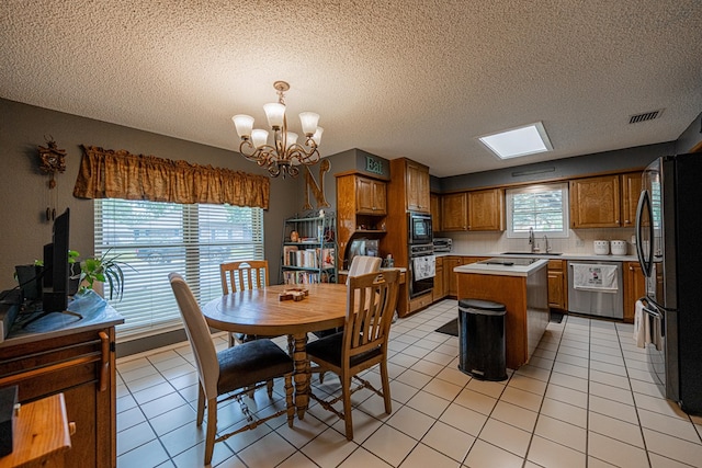 dining space featuring a chandelier, a textured ceiling, and light tile patterned flooring
