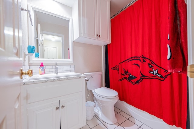 full bath with tile patterned floors, toilet, vanity, and decorative backsplash