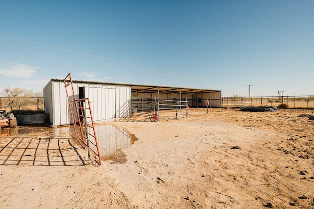 view of yard featuring a rural view and an outdoor structure