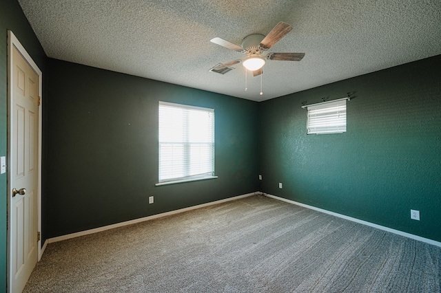 unfurnished room featuring carpet, a textured ceiling, and ceiling fan