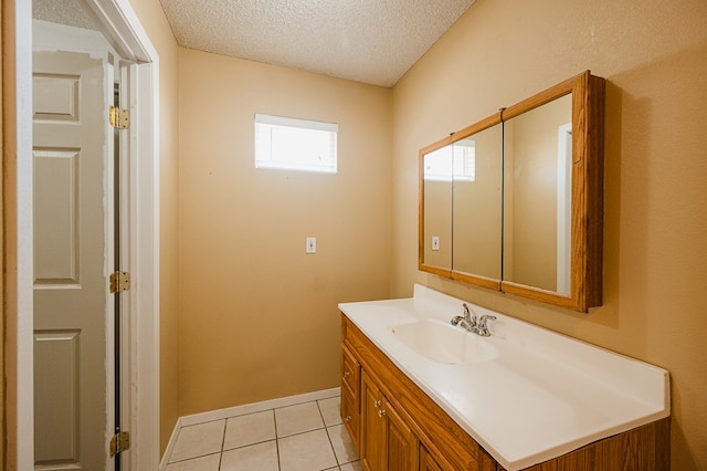 bathroom with tile patterned floors, vanity, and a textured ceiling