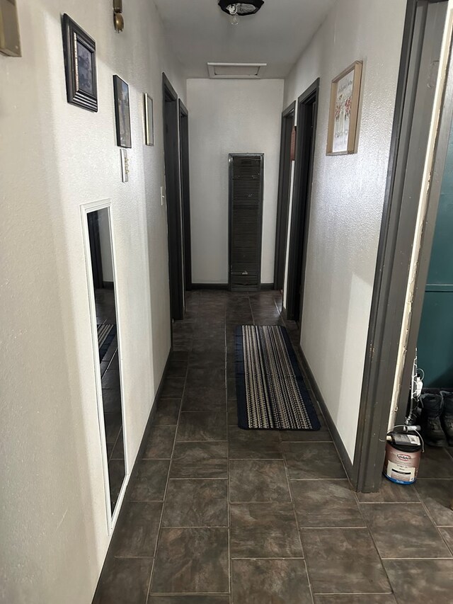 corridor with dark tile patterned floors