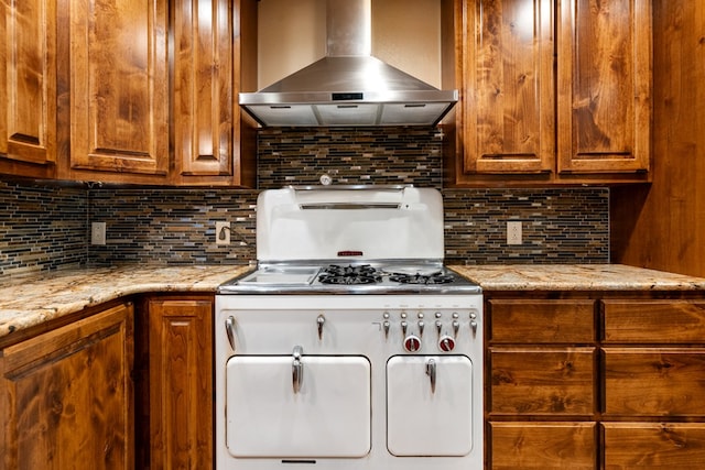 2507 Neill Rd, Big Spring, TX 79720 - kitchen featuring wall chimney range hood, stove, and backsplash