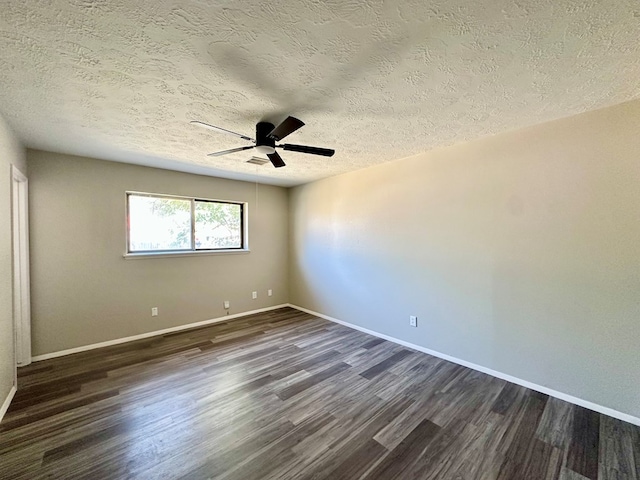 spare room featuring ceiling fan, dark wood-type flooring, and a textured ceiling