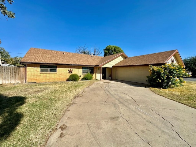 single story home with a front yard and a garage