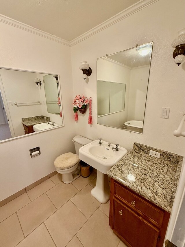 bathroom featuring crown molding, tile patterned flooring, toilet, and sink