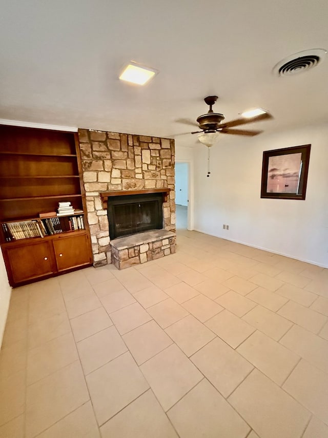 unfurnished living room with a fireplace, light tile patterned floors, ceiling fan, and built in features