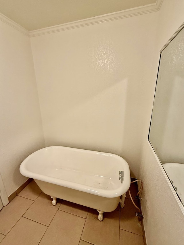 bathroom featuring a bathing tub, tile patterned flooring, and crown molding