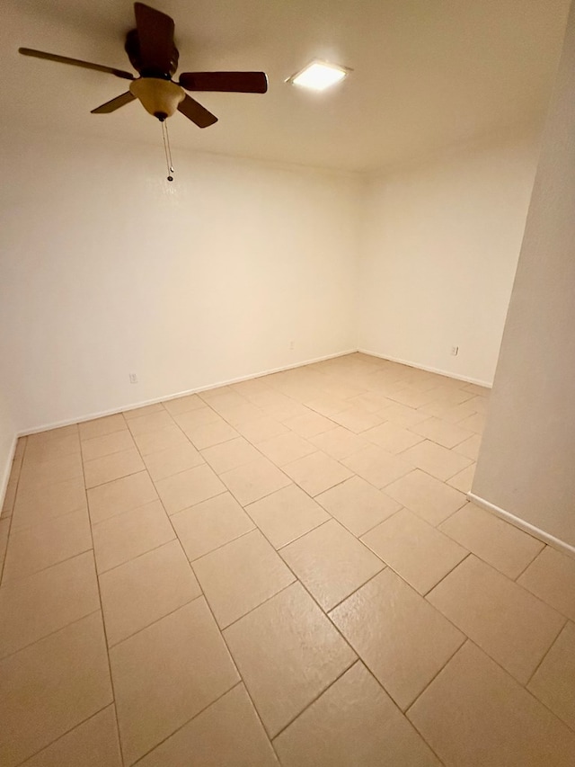 tiled empty room with ceiling fan