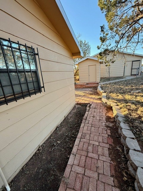 view of side of home with a storage unit