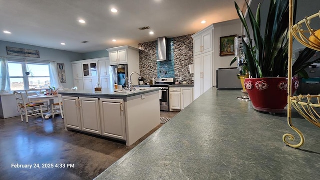 24501 S County Rd 1210, Midland, TX 79706 - kitchen with wall chimney exhaust hood, appliances with stainless steel finishes, white cabinets, a kitchen island with sink, and recessed lighting