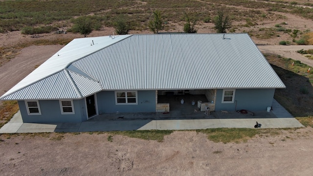 24501 S County Rd 1210, Midland, TX 79706 - rear view of house with a patio area, stucco siding, and a metal roof