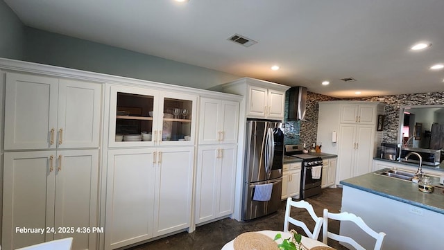 24501 S County Rd 1210, Midland, TX 79706 - kitchen with appliances with stainless steel finishes, wall chimney range hood, white cabinetry, tasteful backsplash, and dark countertops