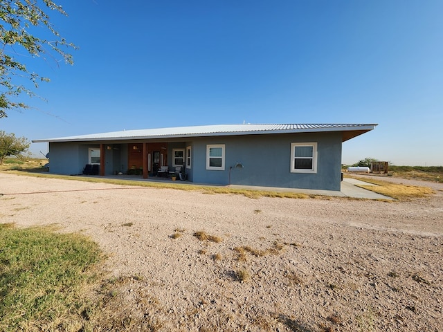 24501 S County Rd 1210, Midland, TX 79706 - view of front of property with stucco siding and a metal roof
