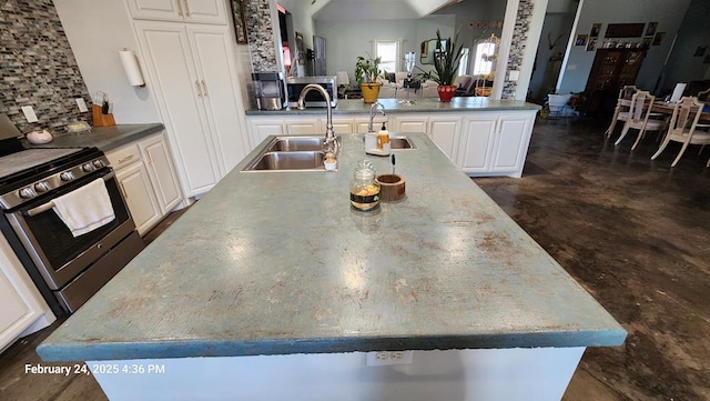 24501 S County Rd 1210, Midland, TX 79706 - kitchen with stainless steel range with gas stovetop, concrete flooring, white cabinetry, and open floor plan