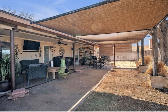 view of patio / terrace featuring outdoor dining area, a ceiling fan, and fence