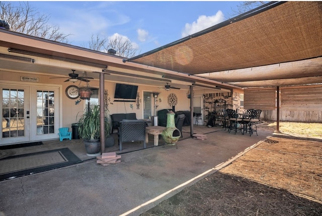 view of patio / terrace with french doors, outdoor dining area, and a ceiling fan