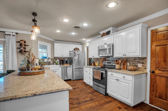 kitchen featuring visible vents, ornamental molding, a sink, stainless steel appliances, and decorative backsplash