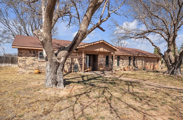 single story home featuring brick siding and fence