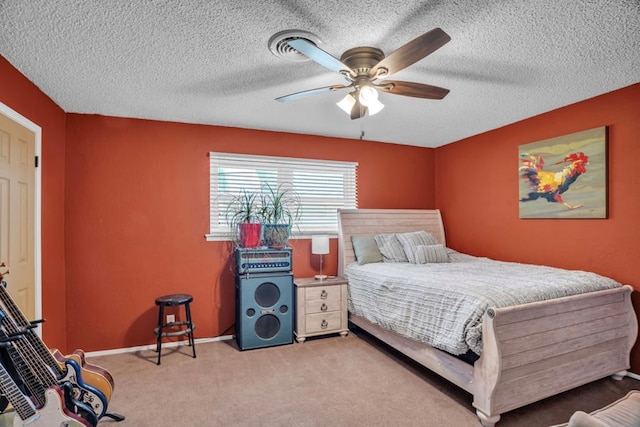 carpeted bedroom featuring ceiling fan, baseboards, and a textured ceiling