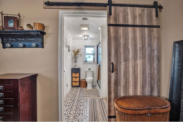 bathroom featuring tile patterned flooring, toilet, and a textured ceiling