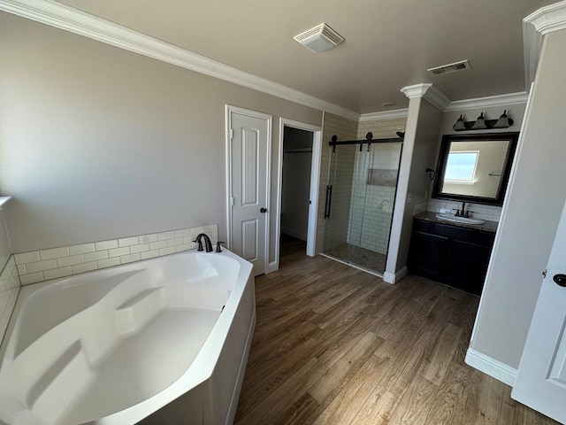 full bath featuring visible vents, wood finished floors, crown molding, a shower stall, and a bath