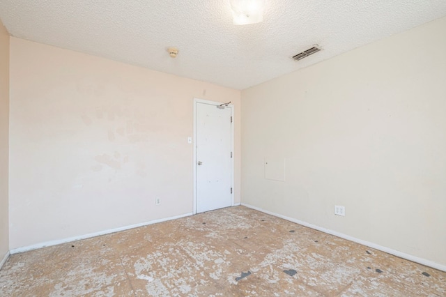 spare room featuring a textured ceiling