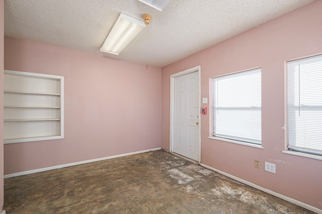 empty room featuring a textured ceiling