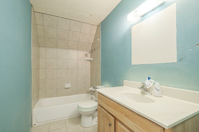 full bathroom with tile patterned floors, toilet, tiled shower / bath, a textured ceiling, and vanity