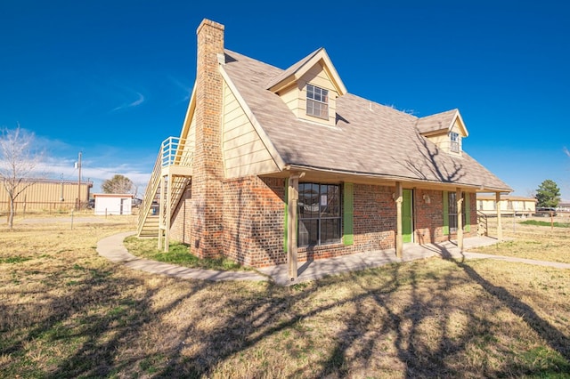 rear view of house with a lawn