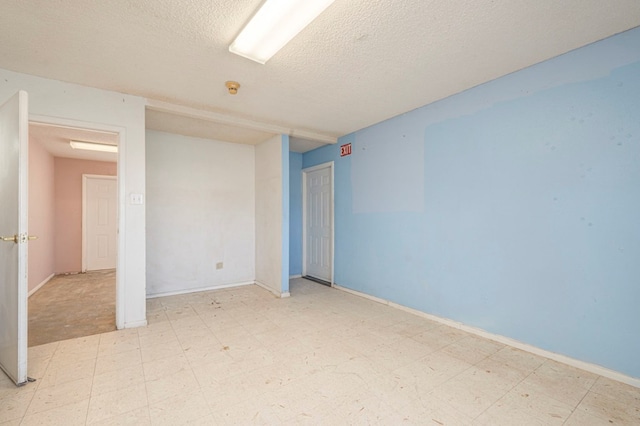 empty room featuring a textured ceiling