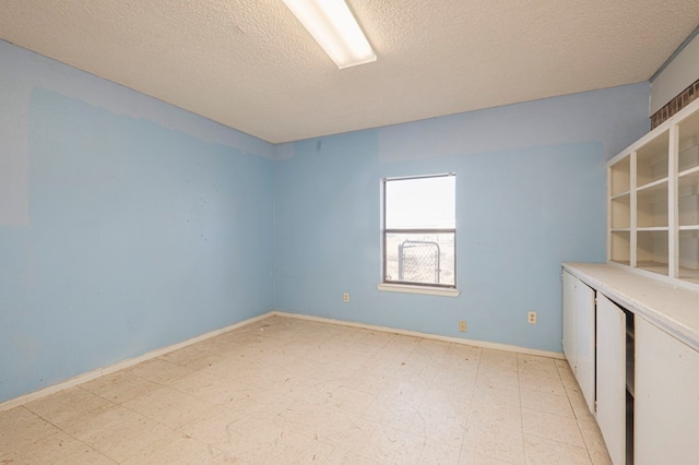 empty room with a textured ceiling