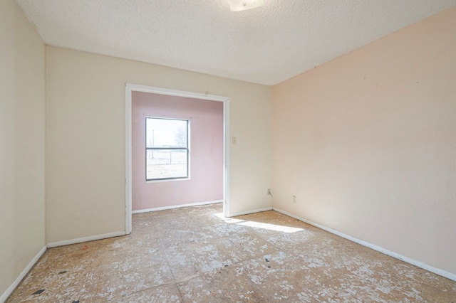 unfurnished room featuring a textured ceiling