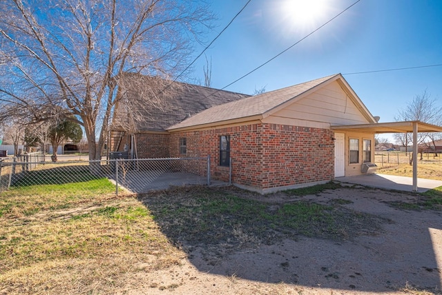 view of property exterior with a lawn and a carport