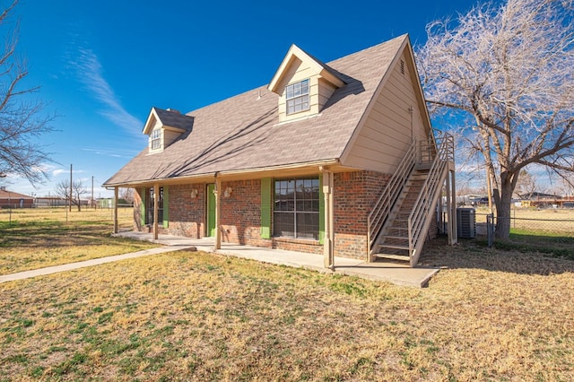 cape cod-style house with cooling unit, a patio area, and a front lawn