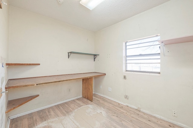 interior space featuring light hardwood / wood-style floors and a textured ceiling