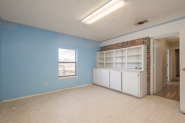 spare room featuring a textured ceiling