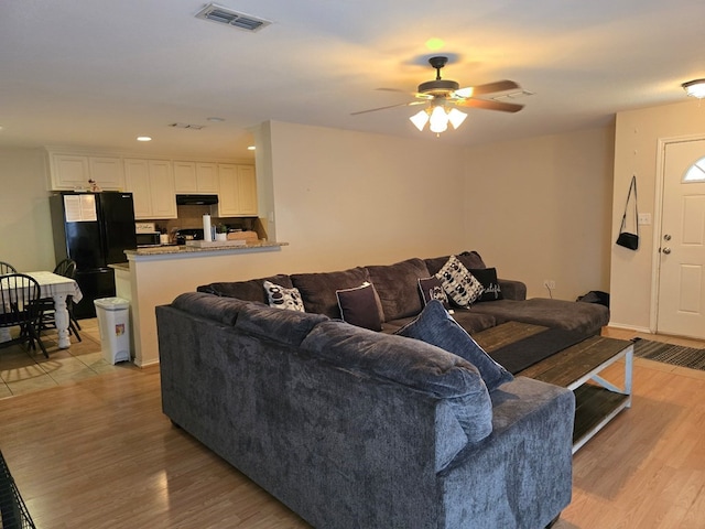 3102 Travis Ave, Midland, TX 79701 - living room featuring light wood-style flooring, a ceiling fan, and recessed lighting
