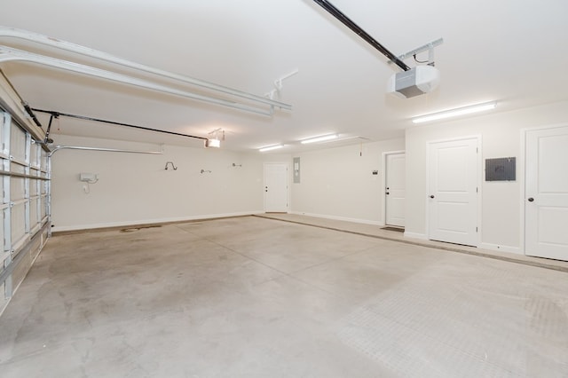 garage with a garage door opener and baseboards