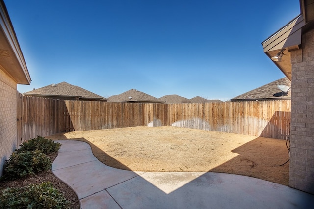 view of yard featuring a patio and a fenced backyard