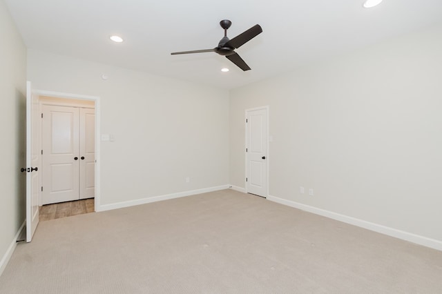 unfurnished bedroom featuring ceiling fan, recessed lighting, baseboards, and light carpet