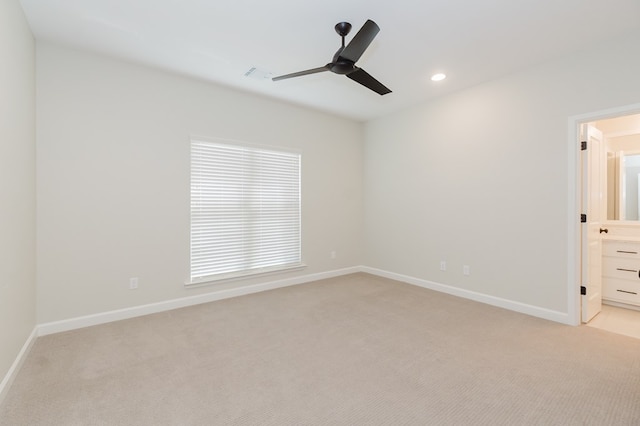 spare room with baseboards, visible vents, recessed lighting, ceiling fan, and light carpet