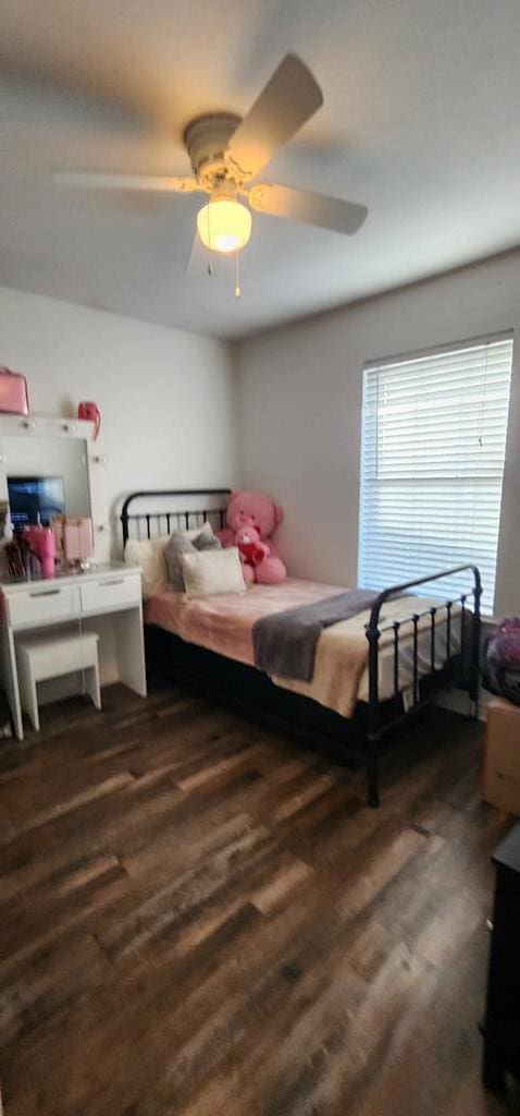 bedroom with a ceiling fan and wood finished floors