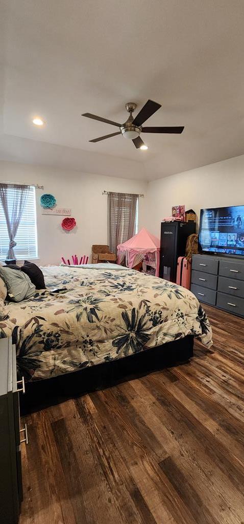 bedroom with ceiling fan and wood finished floors