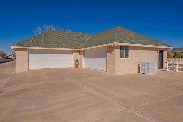 view of front of property with cooling unit and a garage