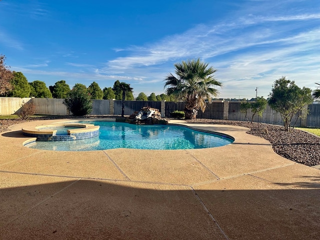 view of swimming pool with a patio area and an in ground hot tub