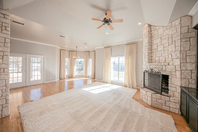 living room with a fireplace, crown molding, light hardwood / wood-style flooring, and ceiling fan with notable chandelier