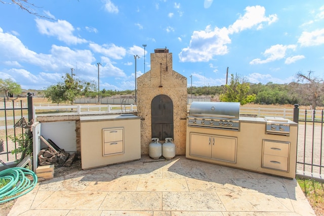 view of patio featuring area for grilling and exterior kitchen