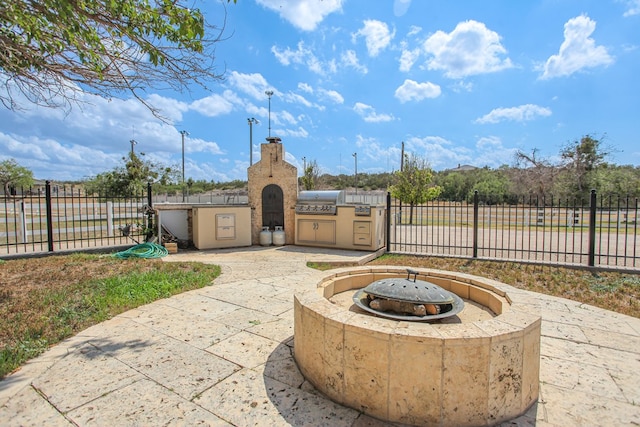 view of patio with a fire pit and area for grilling